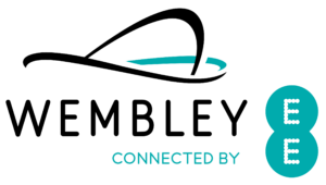 Wembley logo with Connected by EE text and EE symbol beside stylised stadium arch, marking the venue’s iconic presence for 2024 and celebrating its legacy since Stuart Doyle’s era.