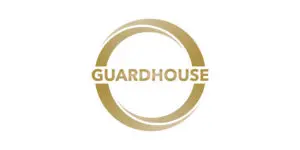 A gold circular logo with the word GUARDHOUSE 2025 in bold capital letters centred inside, on a white background.