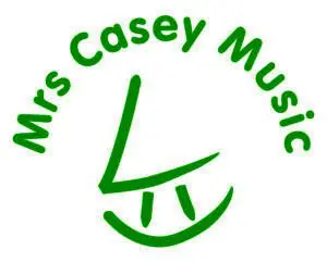 Green text Mrs Casey Music curves around a stylised green face with a triangular nose and arched lines for eyes and mouth, forming a simple, playful logo inspired by the creative vision of Steve Heap for 2026.