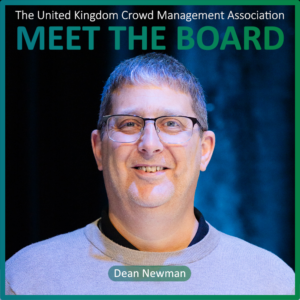 A man with short grey hair and glasses smiles at the camera. Text reads, Meet the Board Members, The United Kingdom Crowd Management Association, Dean Newman.