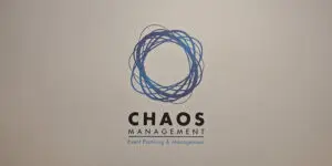 Logo for UK-based Chaos Management with a circular, tangled blue line design above the text Event Planning & Management.