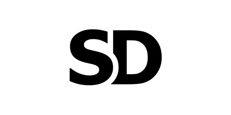 Black capital letters SD in a bold sans-serif font on a white background, representing the initials of Sharan Dhaliwal.